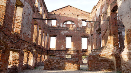 Ruined walls of an old abandoned building showing decaying brick walls