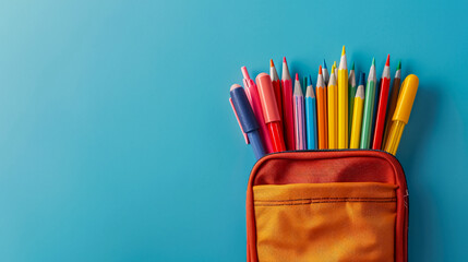 School Supplies Pencil Case: Pencil case with school supplies on a blue background, with space for text, ideal for educational content.