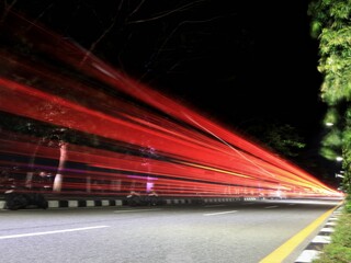 Balikpapan-east Kalimantan November 02,2024 A night time , long exposure view light trails in the street from passing vehicles at balikpapan