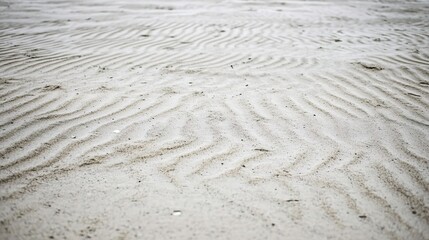 Obraz premium Close-up shot of the patterned texture of sand in an empty desert with ripples and dunes creating intricate patterns that evoke a feeling of solitude and vastness