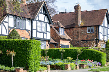 Walking on streets of North London, red brick houses and flowering gardens in spring, city life, wealthy neighbourhoods in London, UK