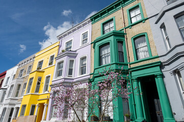 Fototapeta premium Touristic route on Notting Hill, walking on streets with colourful houses, Portobello road, city life, wealthy neighbourhoods in London, UK