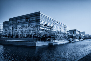 Modern Urban Architecture Reflected in Water with Lush Greenery