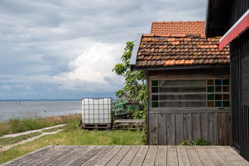 Travelling in France, old wooden huts and oysters farms in Gujan-Mestras village, cultivation and sale of fresh oysters seashells, Arcachon bay, Atlantic ocean, France, tourists destination