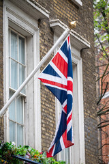 National flag of the United Kingdom is the Union Jack, also known as the Union Flag on houses in central London, UK