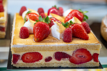 Red fruit sweet dessert cheesecake tart with fresh strawberries in bakery
