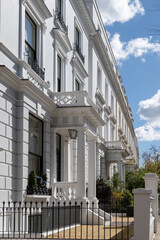 Notting Hill, walking on streets with white houses and flowering gardens in spring, city life,...