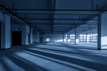 Spacious Commercial Interior with Dramatic Shadows and Natural Light