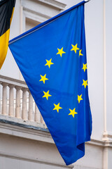 Blue with yellow stars flag of European Union waving on flagpole