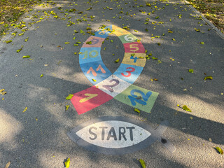 Hopscotch fish shape on an empty alley in the park