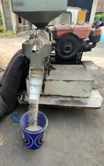 a view of of small rice milling machine in operation