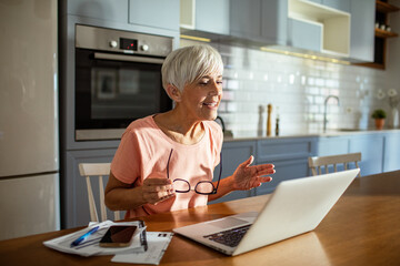 Senior woman working on laptop at home