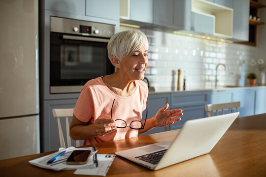 Senior woman working on laptop at home