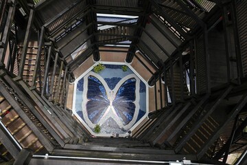 Aerial view of spiral staircase and butterfly mosaic.