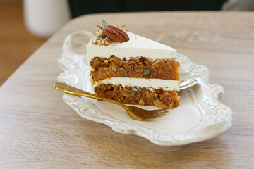 Carrot cake in plate on table at cafe