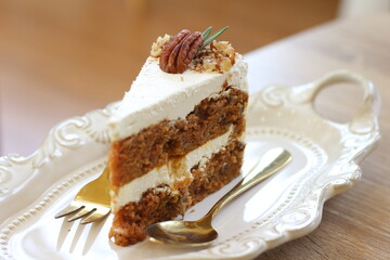 Carrot cake in plate on table at cafe