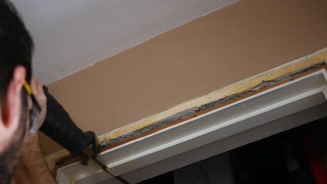 Contractor uses reciprocating saw to cut through old door jamb - 3