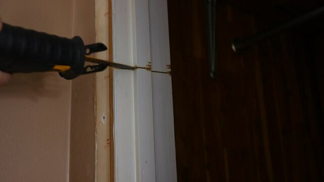 Contractor uses reciprocating saw to cut through old door jamb - 2

