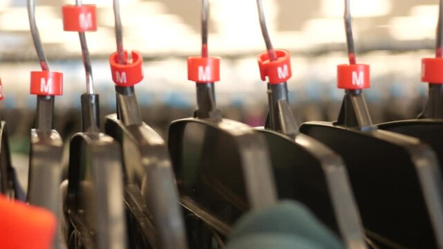 Medium Hangars holding clothes on clothing rack in department store