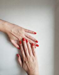 photos of woman's hands with red nails