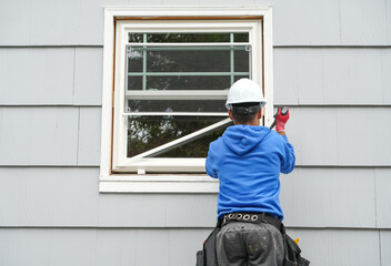 contractor working on replacing the window of the house