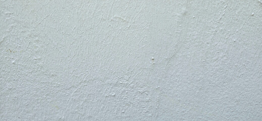Close-up of a white, textured wall with a rough surface