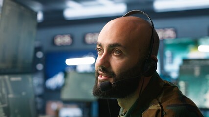 Middle Eastern military dispatcher relays info from army intelligence analysts to troops on front...