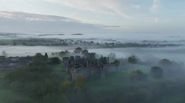 Raglan Castle in the fog at dawn, Monmouthshire, Wales, England