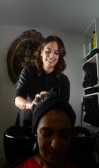 hairdresser drying hair after washing