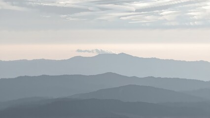 Fototapeta premium Generative AI, Minimalist Aerial View of Serene Mountain Ranges with Soft Cloud Layers