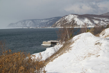 Scenic at the ice-free Angara River flows out of the frozen Lake Baikal. Melted ice floes on blue water.  Located Baikal lake.