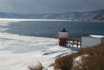 Scenic at the ice-free Angara River flows out of the frozen Lake Baikal. Melted ice floes on blue water.  Located Baikal lake , Russia.