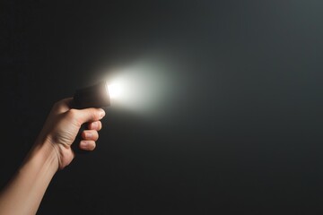 Hand Holding Flashlight in Dark Environment