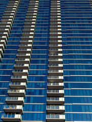 Abstract Background of a Vertical Skyscraper Wall with Blue Reflective Glass.