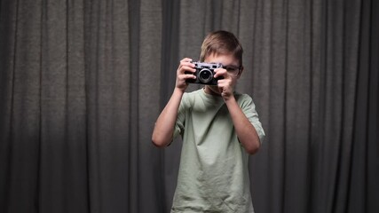 boy in glasses taking pictures with vintage camera - Powered by Adobe
