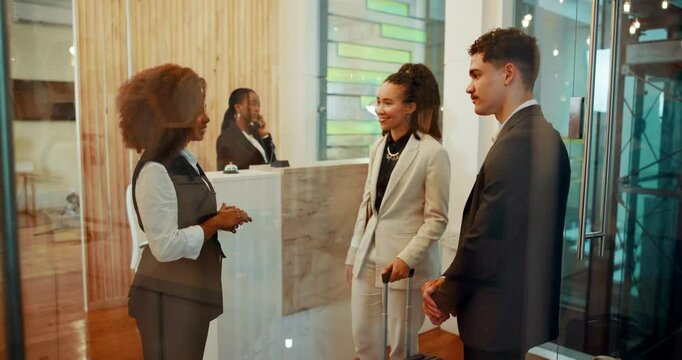 Corporate, people and luggage at reception of hotel for booking, luxury hospitality and concierge service. Staff, talk and receptionist for resort schedule, room availability and reservation check in