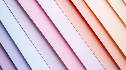 Fototapeta premium Diagonal stripes of colored paper creating a gradient effect, ranging from soft purples and blues to warm pinks and oranges, provide a vibrant and textured backdrop