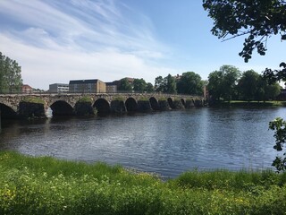 Fototapeta premium Stone Bridge Over Water in Karlstad