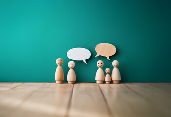 Four wooden figures with smiley faces stand on a wood table in front of a green background, with speech bubbles above their heads.