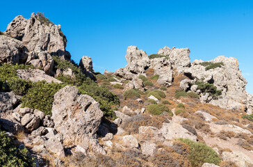 Faces with suffering human features.. Mount Profitis Ilias, the highest on the island of Milos (748 m).