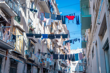 Typical streets in Napoli downtown or old city. Narrow streets with high buildings, clothes hanging...