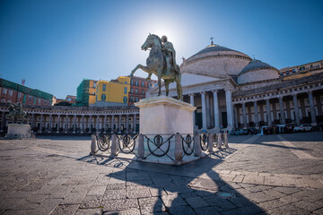 Statues of two equestrian riders on the plebiscito square in napoli city. Big statues rising profoundly in the middle of large square in Napoli..