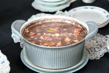 Traditional Brazilian feijoada in a rustic pan