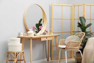 Mirror, dressing table, houseplant, folding screen and chair indoors. Interior design