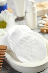 Clean cotton pads on grey table, closeup