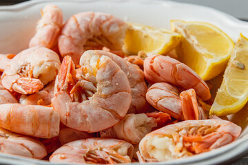 Boiled king prawns in a deep bowl with lemon