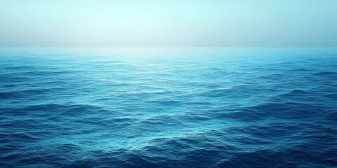 Obraz premium A serene view of the vast ocean, showcasing gentle waves in varying shades of blue. The tranquil atmosphere evokes a sense of peace and calmness.