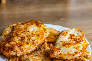 cooked chicken chops on white plate on table close up