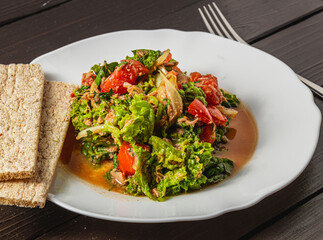 vegetable salad with tuna dressed with natural honey and rye bread
