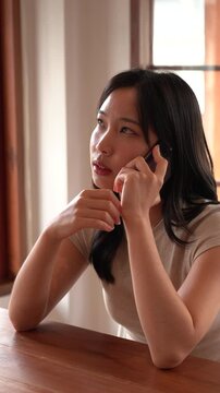 Asian woman talking with her phone